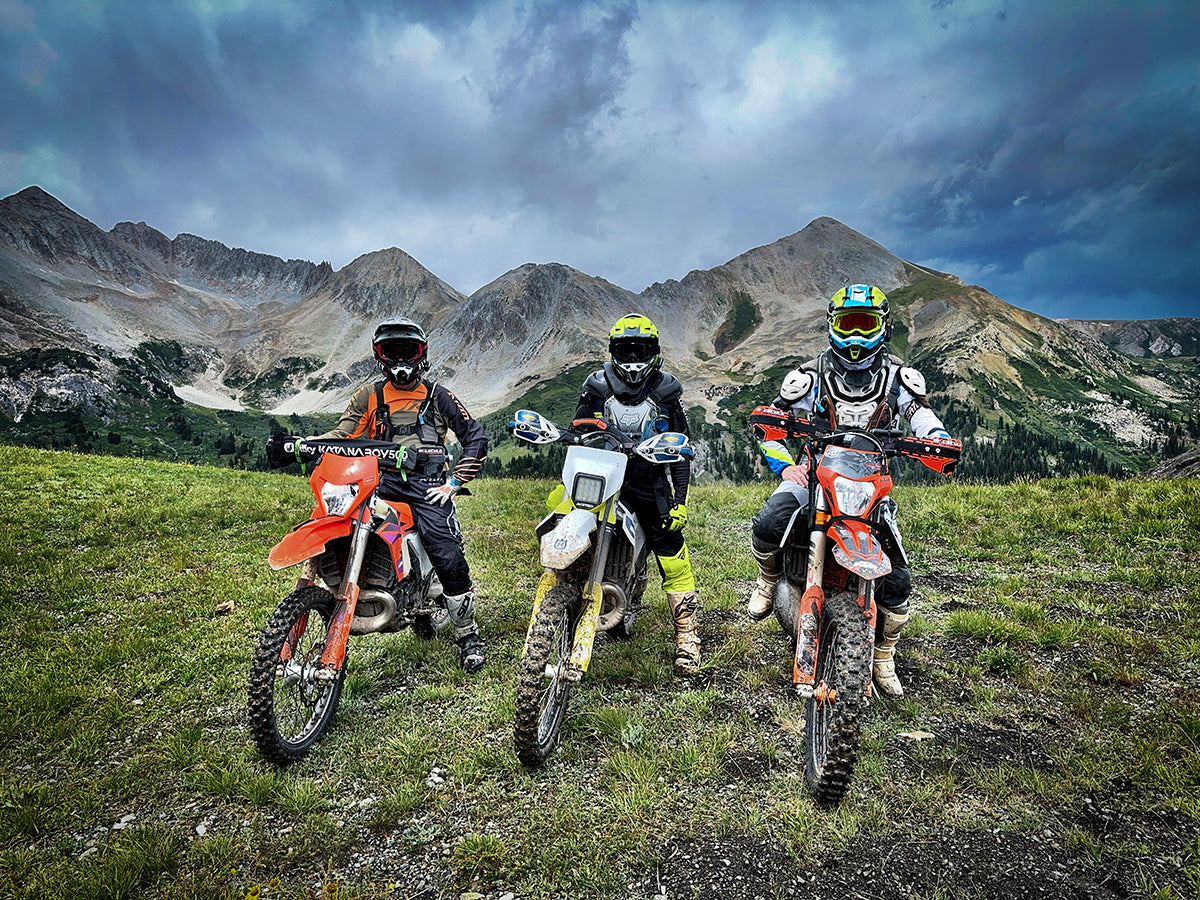 Gold Rush Ride - 3 riders on bikes with mountains in background