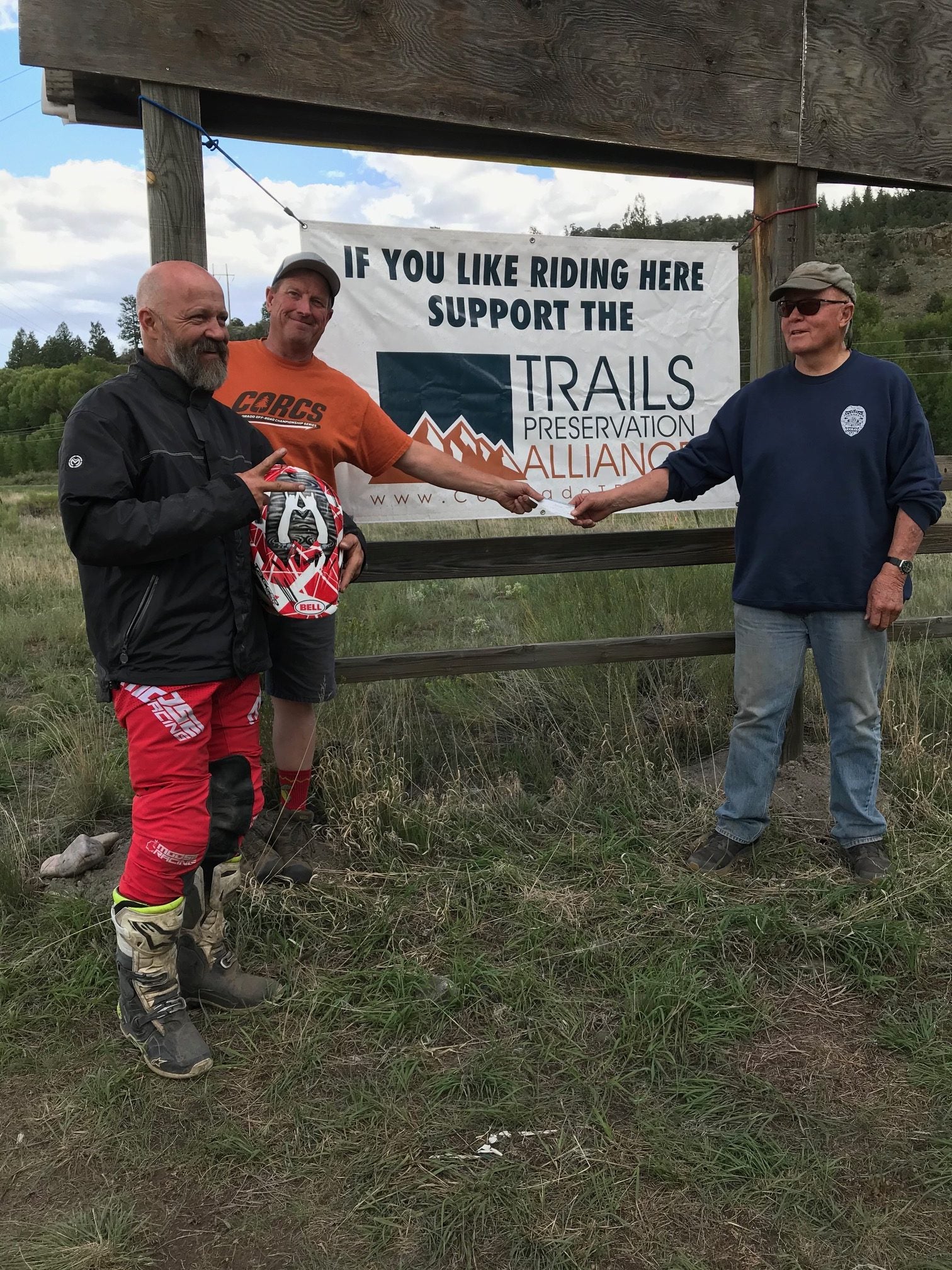 Jud Barlow hands Don Riggle a check for the TPA