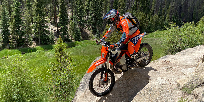 Rider on bike going over boulders